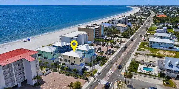 Image 2: Coastal property situated directly across from a sandy beach and expansive ocean - Virtually Edited Image