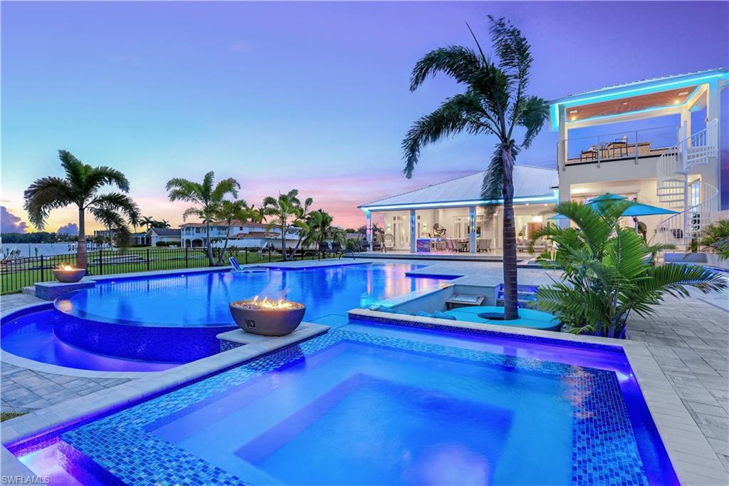 Image 1: View of swimming pool with an in-ground hot tub and a patio area
