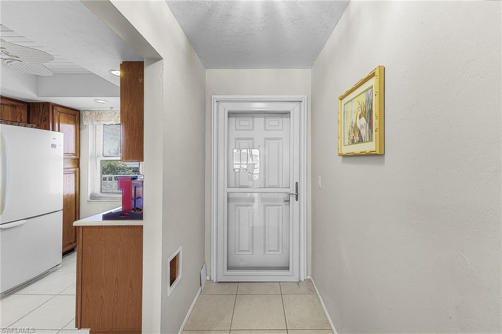 Image 2: Entryway with tile floor and a textured ceiling