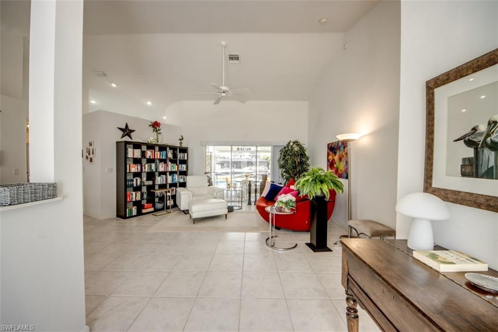 Image 4: Living area featuring ceiling fan, light tile patterned flooring, recessed lighting, and lofted ceiling