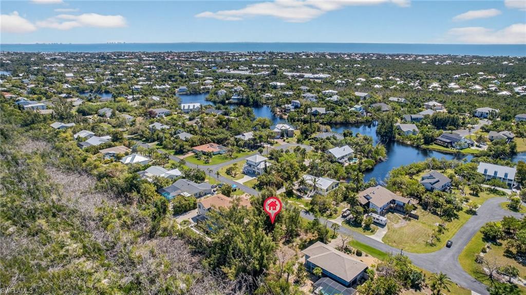 Image 2: Aerial view of residential area with a large body of water