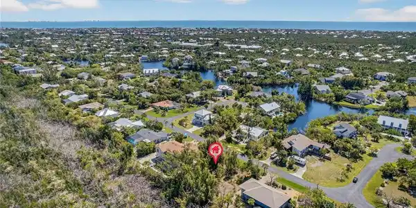 Image 2: Aerial view of residential area with a large body of water