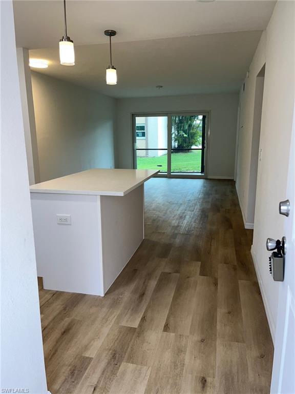 Image 3: Hall with wood finished floors and baseboards