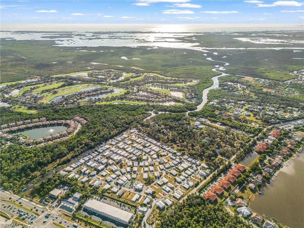 Image 3: Aerial view of property and surrounding area with a large body of water and nearby suburban area
