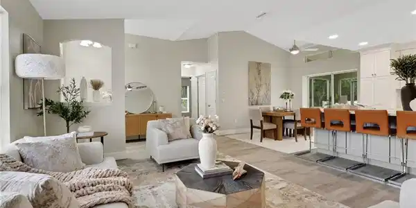 Image 3: Open-concept living area featuring vaulted ceilings, wood-finish flooring, recessed lighting, and a ceiling fan