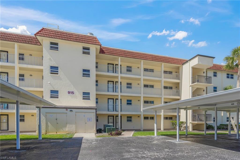 Image 2: View of apartment building / complex with covered parking
