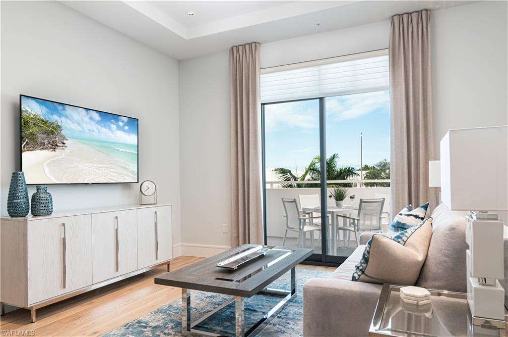Image 2: Living room with sunset view balcony