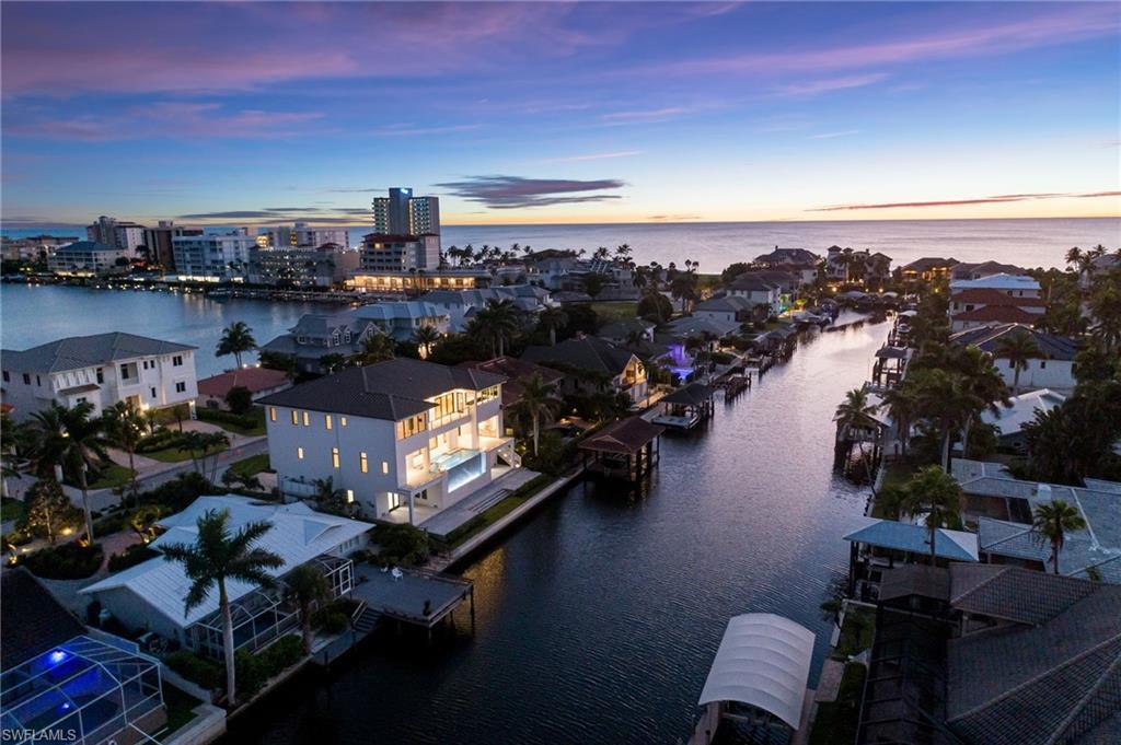 Image 3: Aerial view of residential area with a nearby body of water