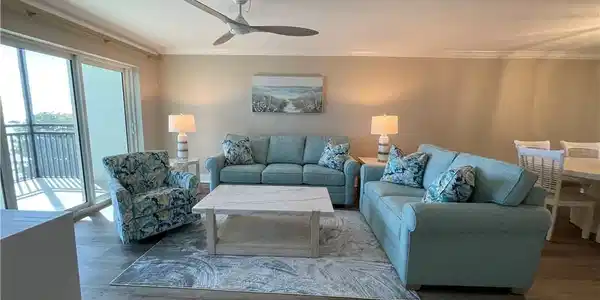 Image 4: Living area with ornamental molding, wood finished floors, and a ceiling fan