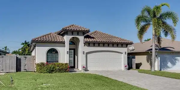 Image 2: Mediterranean / spanish-style house featuring decorative driveway, stucco siding, a garage, and a gate