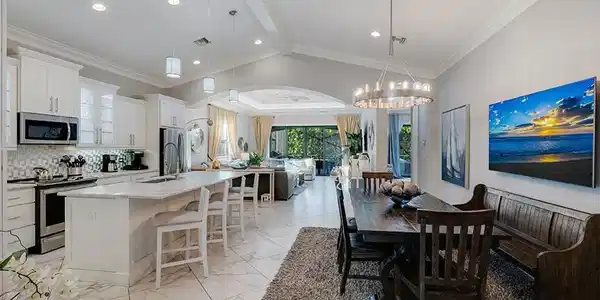 Image 4: Dining area with light marble finish floors, vaulted ceiling, and ornamental molding