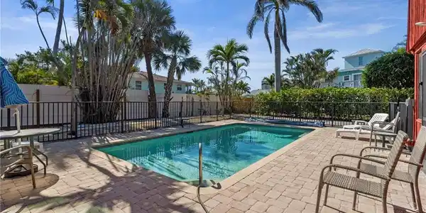 Image 4: View of swimming pool with fence and a patio area - Virtually Edited Exterior Image