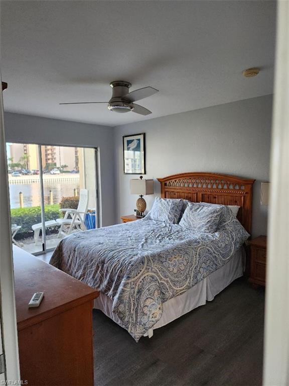 Image 3: Sleeping area with wood-finish flooring and a ceiling fan