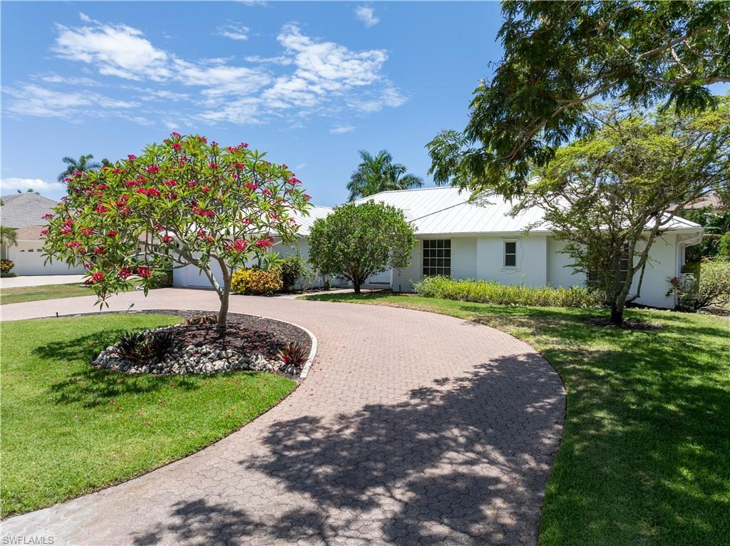 Image 2: Ranch-style home with a front yard
