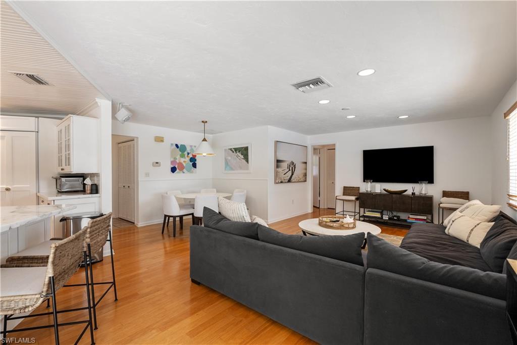 Image 3: Living room with light wood-type flooring