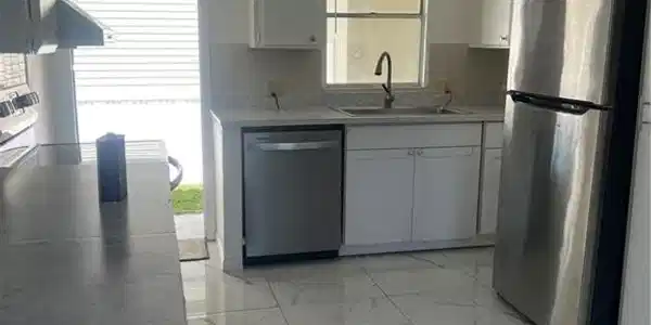 Image 3: Kitchen with a ceiling fan, stainless steel dishwasher, a sink, decorative backsplash, and fridge