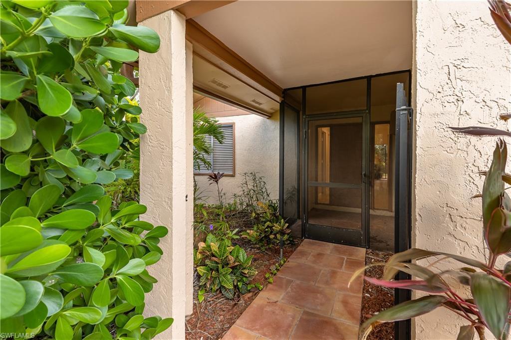 Image 3: Entrance to property with stucco siding