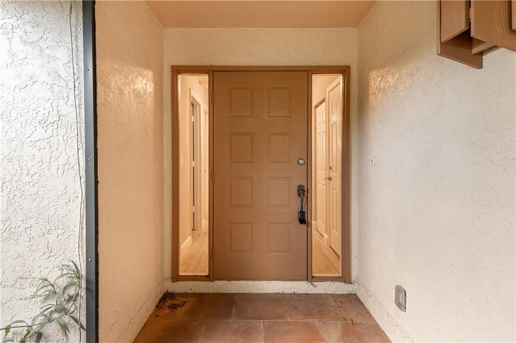 Image 4: Entrance to property with stucco siding