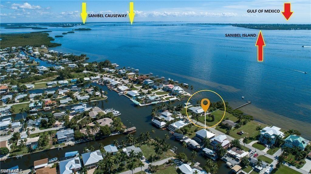 Image 2: Aerial perspective of suburban area featuring a large body of water