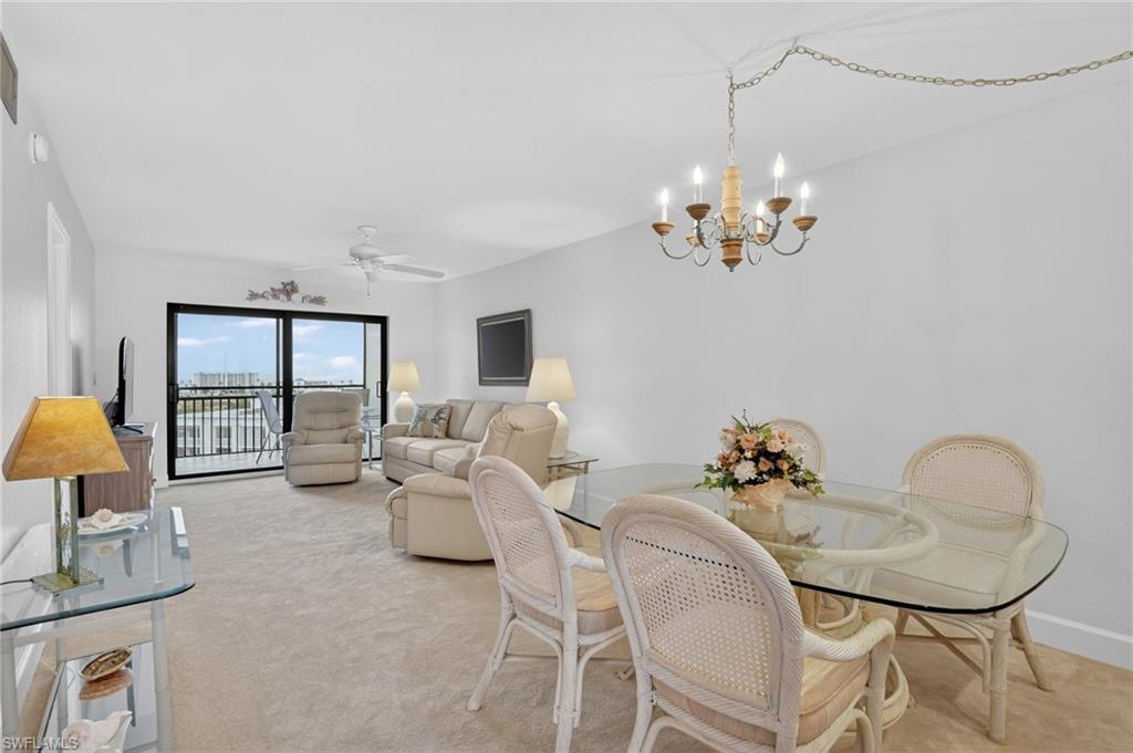 Image 4: Dining space featuring suspended lighting, ceiling fan, and light colored carpet