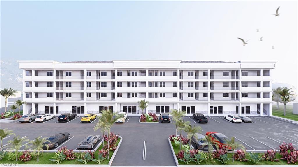 Image 1: View of apartment building / complex featuring uncovered parking