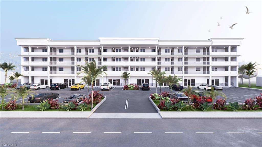 Image 2: View of apartment building / complex featuring uncovered parking