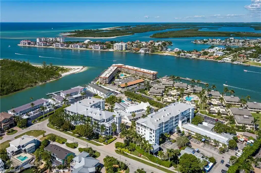 Image 1: Aerial perspective showcasing coastal properties situated on waterways with direct Gulf access