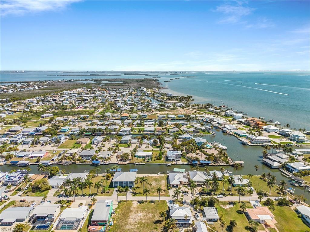 Image 1: Aerial perspective of suburban area featuring a large body of water