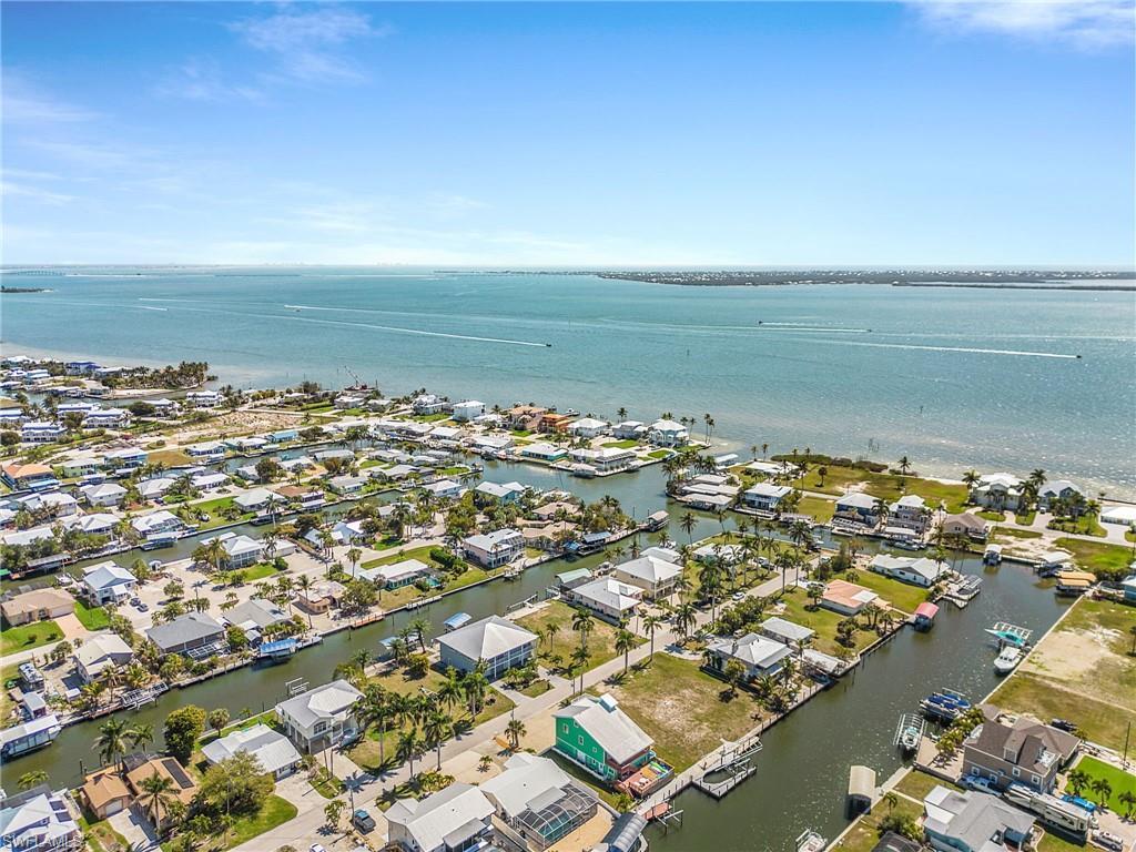 Image 2: Aerial perspective of suburban area with a nearby body of water
