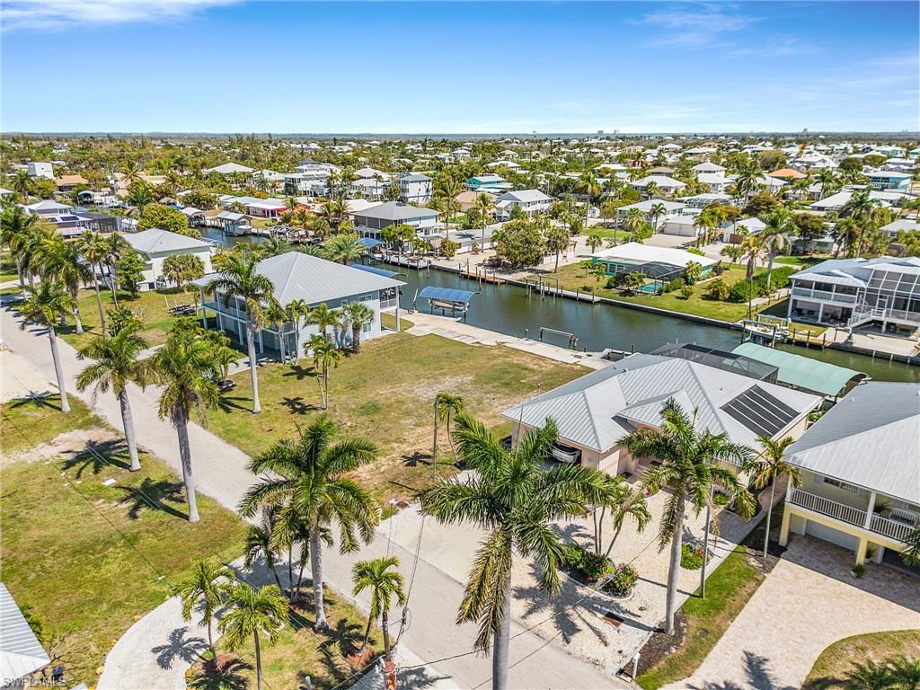 Image 4: Aerial view of residential area with a large body of water