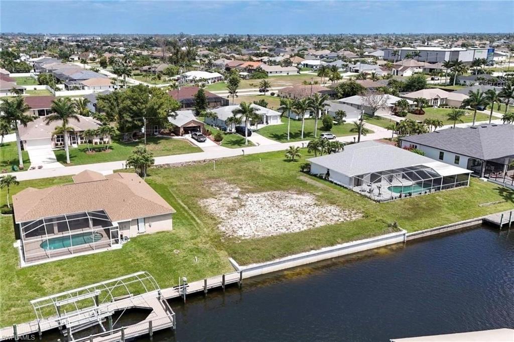 Image 2: Aerial perspective of suburban area with a nearby body of water