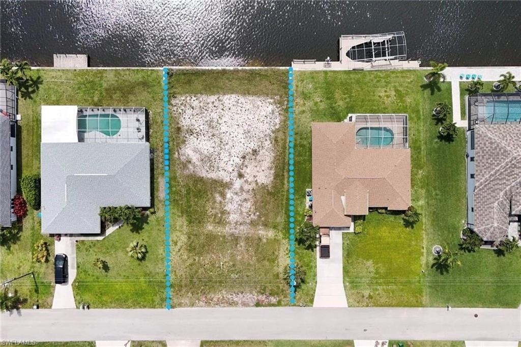 Image 3: Aerial perspective of suburban area with a nearby body of water