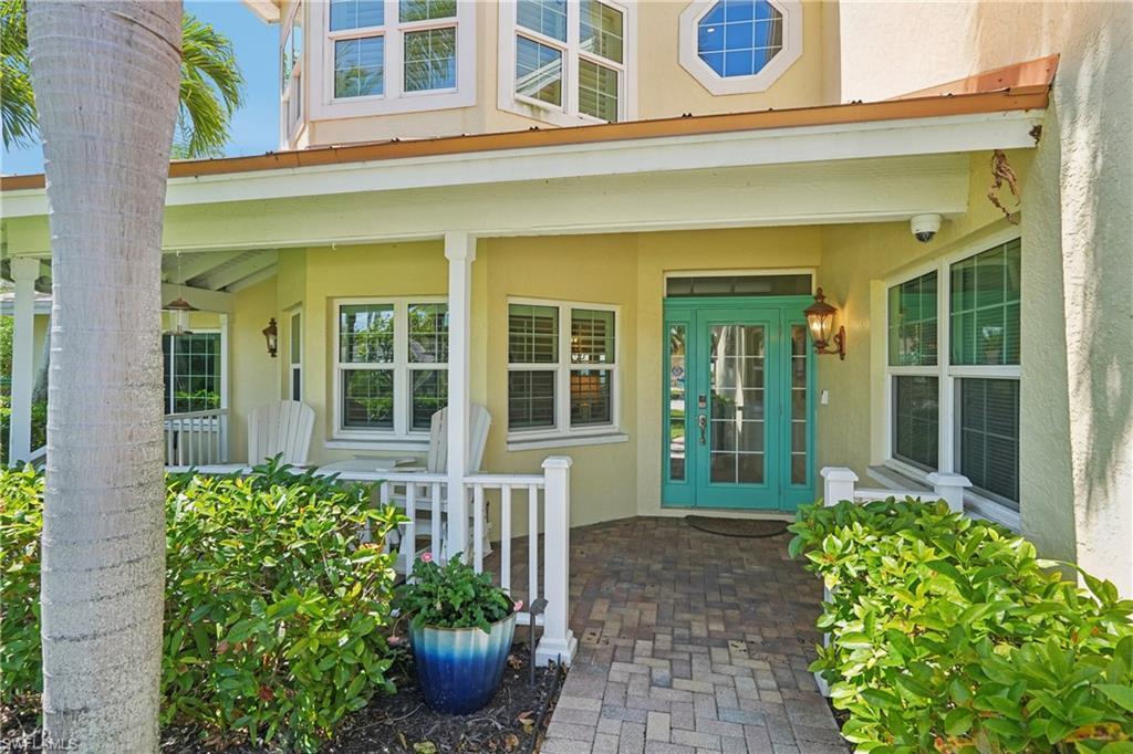 Image 3: Doorway to property featuring stucco siding and a porch
