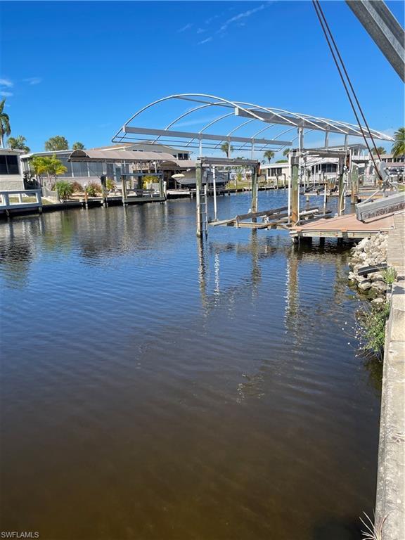 Image 2: Dock with boat lift and a water view