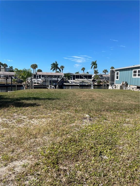 Image 4: View of grassy yard with a water view