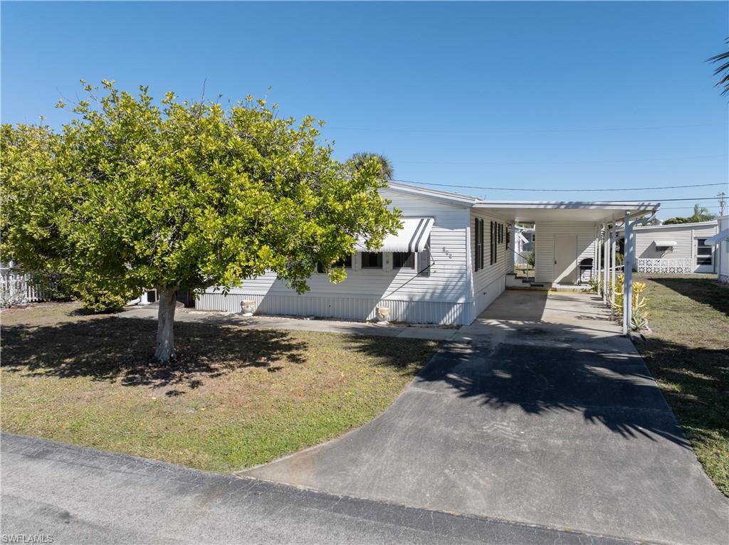 Image 4: Manufactured / mobile home with a carport and driveway