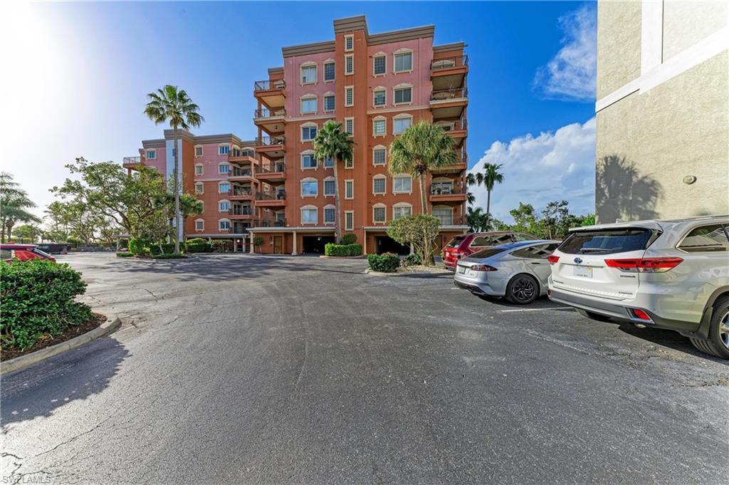 Image 2: View of apartment building / complex with uncovered parking