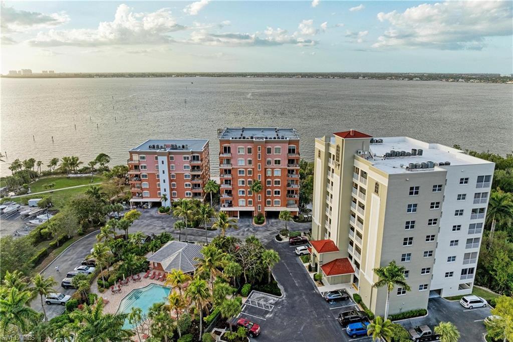 Image 3: Drone / aerial view of apartment complex / building and a nearby body of water