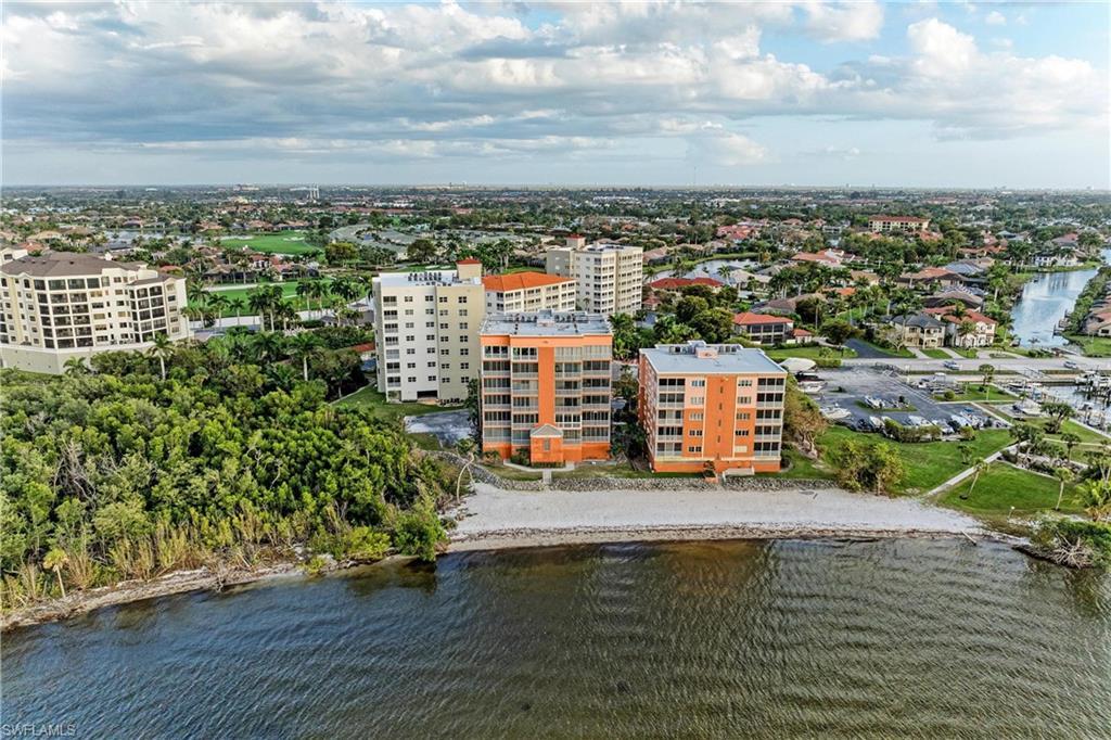 Image 4: Aerial view of a nearby body of water and apartment complex