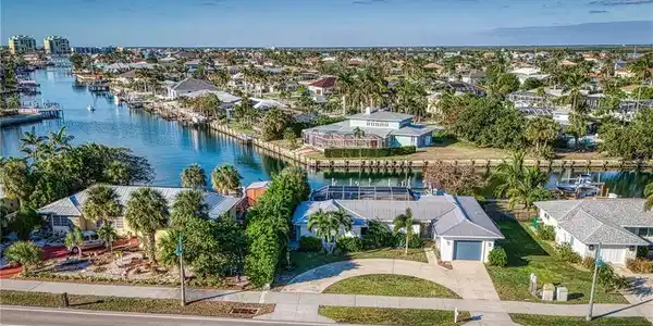 Image 4: Aerial view of residential area with a nearby body of water