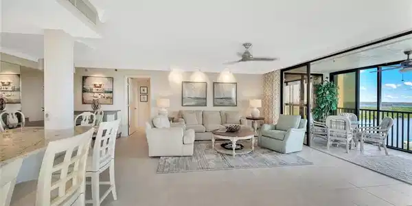 Image 4: Living room featuring a ceiling fan, floor to ceiling windows, light tile patterned floors, and crown molding