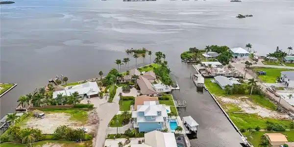 Image 3: Aerial perspective of suburban area with a large body of water