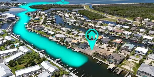 Image 3: Waterfront property with direct canal access, private boat slips, and proximity to open water