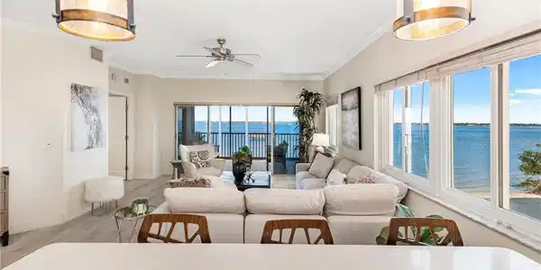 Image 4: Living area featuring a water view, wood finished floors, crown molding, and a ceiling fan