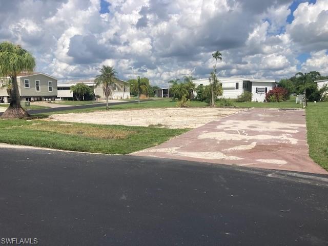 Image 1: View of grassy yard with driveway