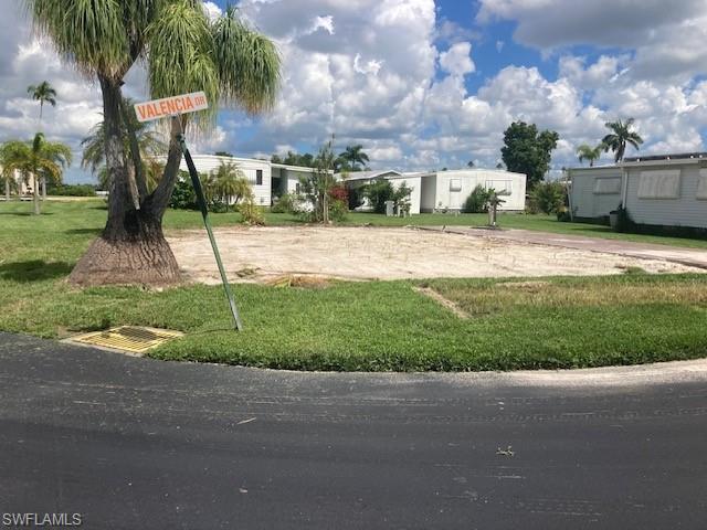 Image 2: View of home's community with a lawn