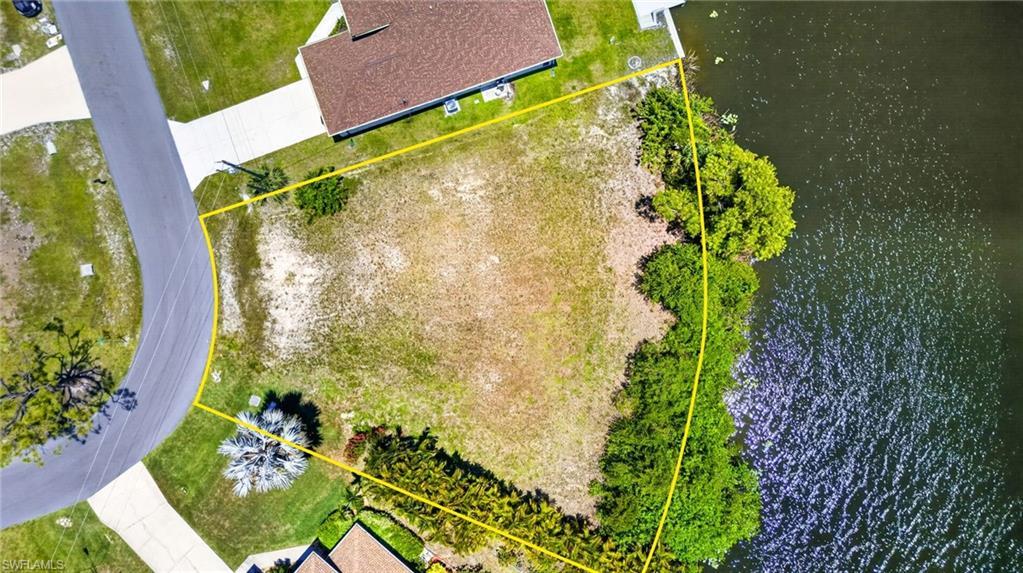 Image 1: Waterfront lot with established vegetation along the water's edge