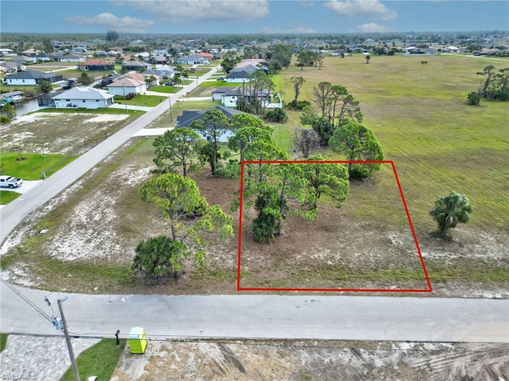 Image 1: Aerial view of property and surrounding area featuring property parcel outlined