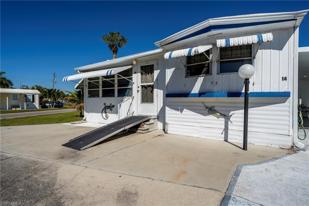 Image 2: View of front of house, light post, driveway, and wheelchair ramp