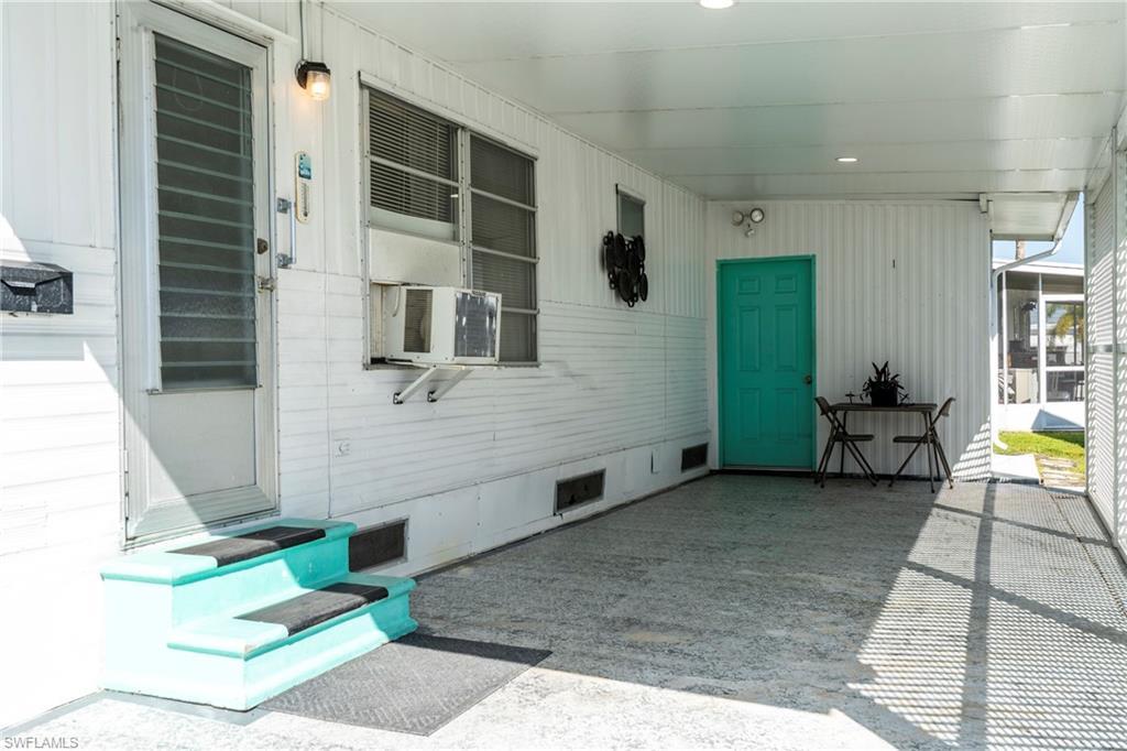 Image 4: View of paved carport area with entrance door